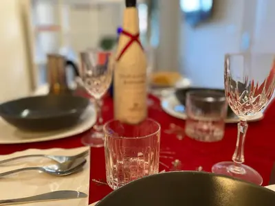 a bottle of wine sitting on a table with glasses at Red House Trastevere San Pietro Bambin Gesú Sant Onofrio Appartamento Roma in Rome