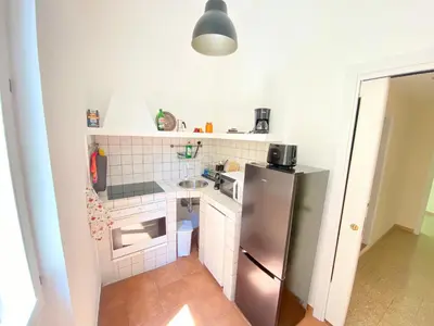 a small kitchen with a stainless steel refrigerator at Red House Trastevere San Pietro Bambin Gesú Sant Onofrio Appartamento Roma in Rome