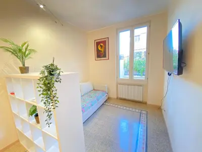 a living room with a couch and a tv at Red House Trastevere San Pietro Bambin Gesú Sant Onofrio Appartamento Roma in Rome