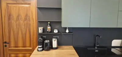 a kitchen with a coffee maker on a counter at Nox Romana Apartments - Vatican - Modern Apt with Cozy Balcony in Rome