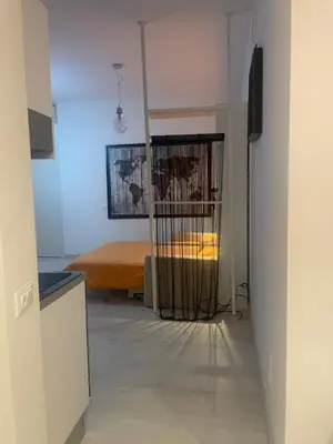 a hallway leading to a bedroom with a bed at Chez Margot in Rome
