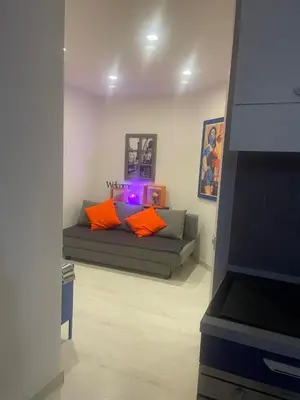 a living room with a couch with orange pillows at Chez Margot in Rome