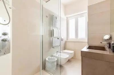 a bathroom with a toilet and a glass shower at Vatican Flat in Rome