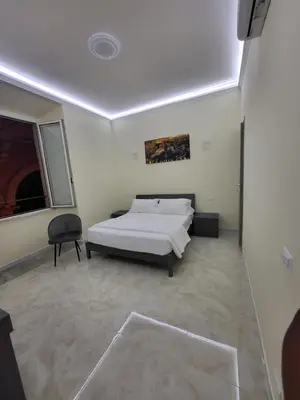 a bedroom with a bed and a chair in it at Rome Jubilee Stays in Rome