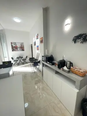 a kitchen with a counter and chairs in a room at Rome Jubilee Stays in Rome