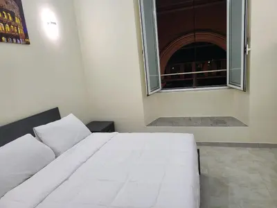 a white bed in a room with a window at Rome Jubilee Stays in Rome