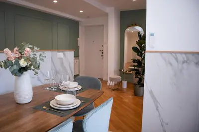 a dining room with a table with a vase of flowers at The Aristocats Apartment in Rome
