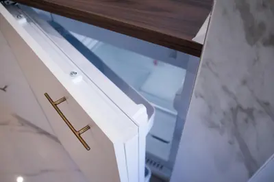 a white drawer with a gold handle on a desk at The Aristocats Apartment in Rome