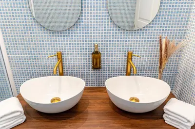 a bathroom with two white sinks and two mirrors at The Aristocats Apartment in Rome