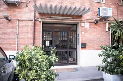 a door to a brick building with a window at The Aristocats Apartment in Rome