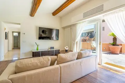 a living room with a couch and a tv at iFlat Luxury Penthouse near Trevi Fountain in Rome