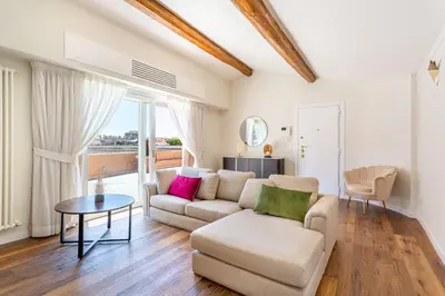 a living room with a couch and a table at iFlat Luxury Penthouse near Trevi Fountain in Rome