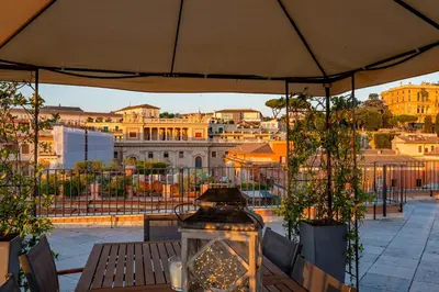 a patio with a table with a view of a city at iFlat Luxury Penthouse near Trevi Fountain in Rome