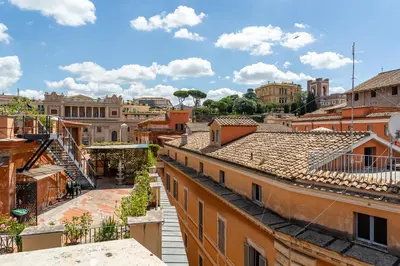 a view of the city from the roofs of buildings at iFlat Luxury Penthouse near Trevi Fountain in Rome