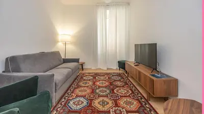 a living room with a couch and a flat screen tv at Testaccio's Heart by Rentbeat in Rome