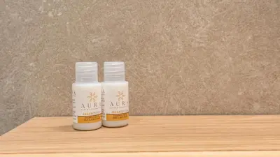 two bottles of moisturizers sitting on a wooden table at Testaccio's Heart by Rentbeat in Rome
