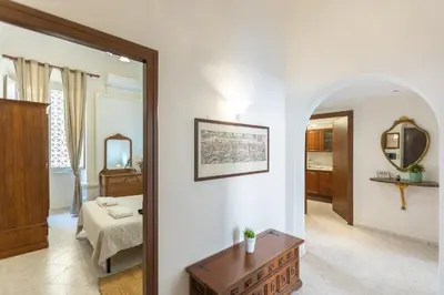 a living room with a bed and a mirror at Pietroburgo by Rental in Rome in Rome