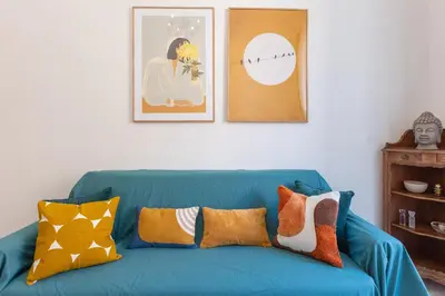 a blue couch with pillows on it in a living room at Pietroburgo by Rental in Rome in Rome