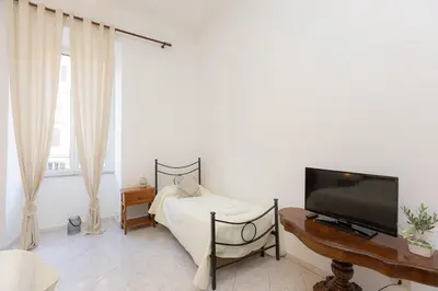 a bedroom with a bed and a flat screen tv at Pietroburgo by Rental in Rome in Rome