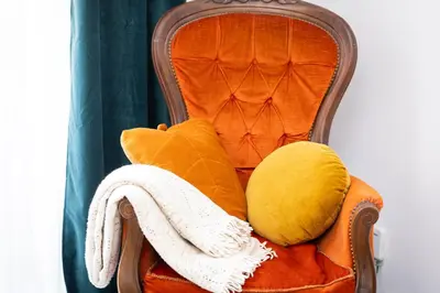 an orange chair with pillows and towels on it at Pietroburgo by Rental in Rome in Rome