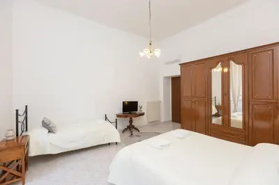 a bedroom with two beds and a desk and a tv at Pietroburgo by Rental in Rome in Rome