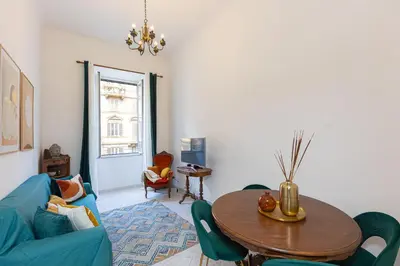 a living room with a blue couch and a table at Pietroburgo by Rental in Rome in Rome
