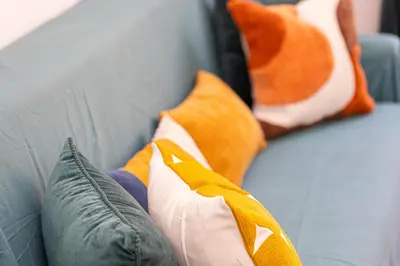 a gray couch with pillows on top of it at Pietroburgo by Rental in Rome in Rome