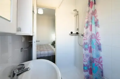 a bathroom with a shower with a sink and a toilet at Magenta Collection Terrione 19 in Rome