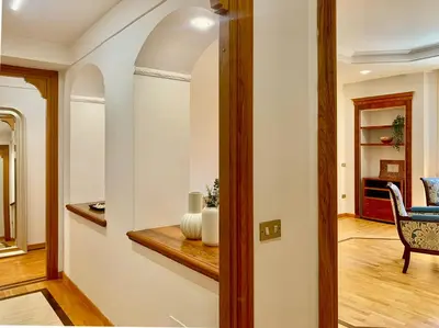 a hallway with a table with a vase on it at DaliTourism - Colosseo Prestige Apartment in Rome