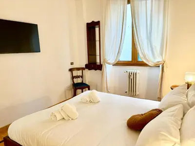 a bedroom with a white bed with towels on it at DaliTourism - Colosseo Prestige Apartment in Rome