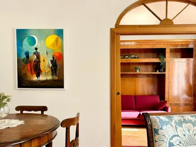a dining room with a table and a pink couch at DaliTourism - Colosseo Prestige Apartment in Rome