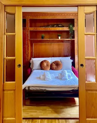 a bunk bed with two pillows on top of it at DaliTourism - Colosseo Prestige Apartment in Rome