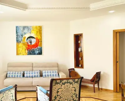 a living room with a couch and a painting on the wall at DaliTourism - Colosseo Prestige Apartment in Rome