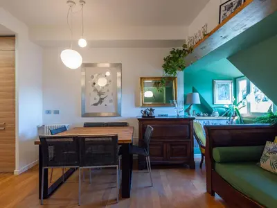 a dining room with a table and a couch at Apartment Tiziano by Interhome in Rome