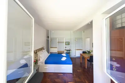 a bedroom with a blue bed and a desk at Villino San Cosimato, nel cuore di Trastevere in Rome