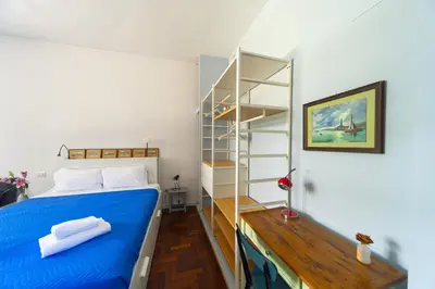 a bedroom with a blue bed and a shelf at Villino San Cosimato, nel cuore di Trastevere in Rome