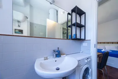 a bathroom with a sink and a washing machine at Villino San Cosimato, nel cuore di Trastevere in Rome