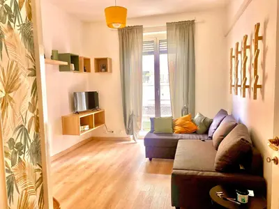 a living room with a purple couch and a tv at Casa Carlotta a Roma in Rome
