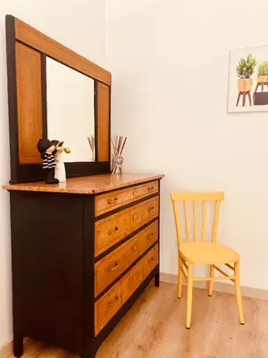 a dresser with a mirror and a chair in a room at Casa Carlotta a Roma in Rome
