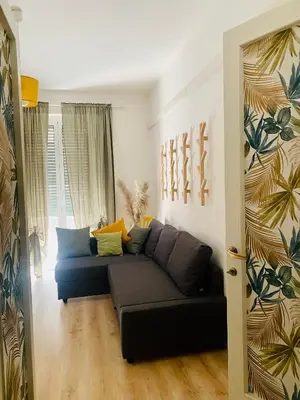 a living room with a blue couch in a room at Casa Carlotta a Roma in Rome