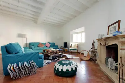 a living room with a blue couch and a fireplace at Charming Minerva - My Extra Home in Rome