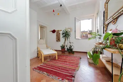 a living room with a red rug on the floor at Charming Minerva - My Extra Home in Rome