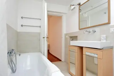 a bathroom with a white tub and a sink at Charming Minerva - My Extra Home in Rome