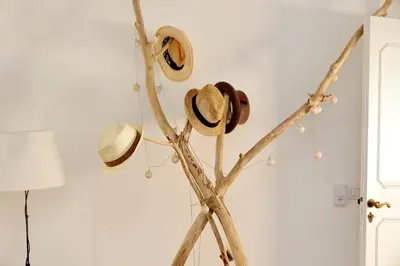 a group of hats hanging on a tree branch at Charming Minerva - My Extra Home in Rome