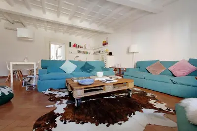 a living room with a blue couch and a coffee table at Charming Minerva - My Extra Home in Rome