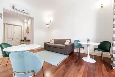 a living room with a couch and a table and chairs at Splendido appartamento a Villa Ada in Rome