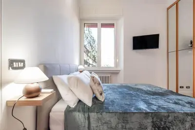 a bedroom with a bed and a lamp and a window at Splendido appartamento a Villa Ada in Rome