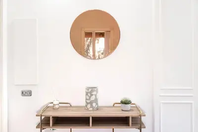 a table with a mirror on a white wall at Splendido appartamento a Villa Ada in Rome