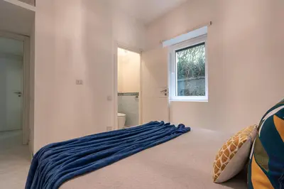 a bedroom with a bed with a blue blanket on it at DiTullio18 - Cipro Balduina in Rome
