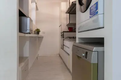 a kitchen with white counters and a microwave at DiTullio18 - Cipro Balduina in Rome